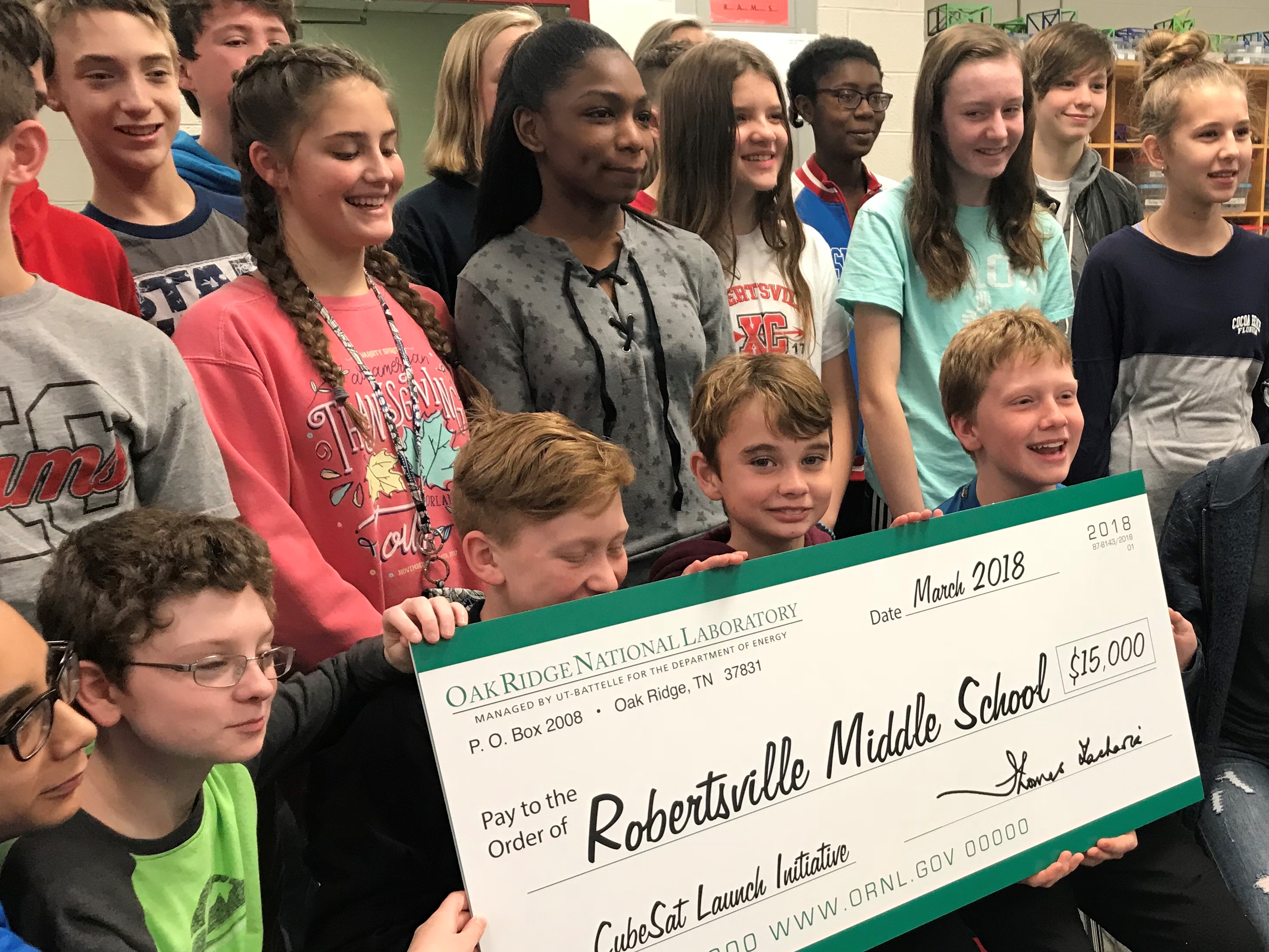 Students with giant check