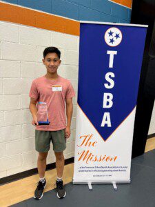 Brian Qu poses with TSBA Regional Student Recognition Award